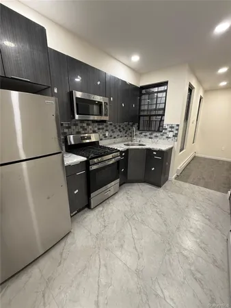 a large kitchen with cabinets and stainless steel appliances