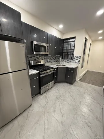 a large kitchen with cabinets and stainless steel appliances