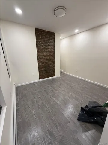 an empty room with wooden floor