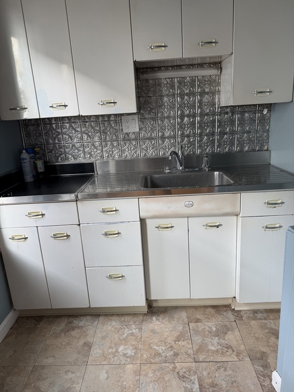 29 Boardman Street, Unit 2 Worcester, MA 01606 - Photo 3 of 16 a kitchen with white cabinets and a stove