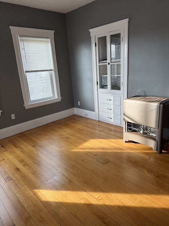 29 Boardman Street, Unit 2 Worcester, MA 01606 - Photo 8 of 16 a view of an empty room with wooden floor and a window
