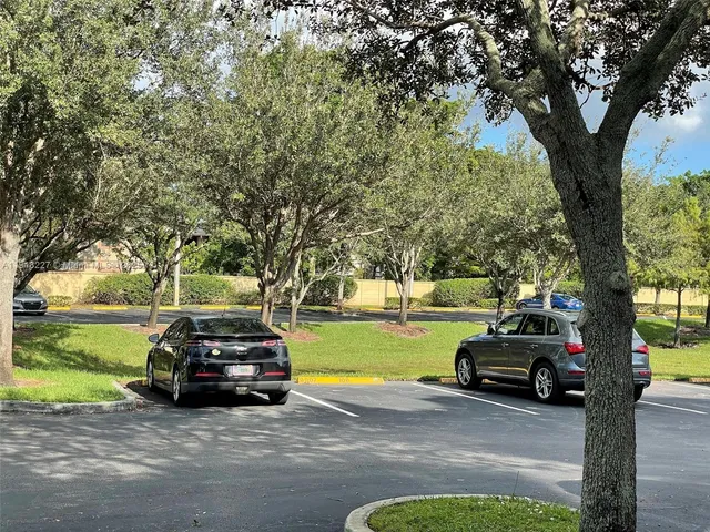 a view of a car parked in front of a house with a yard