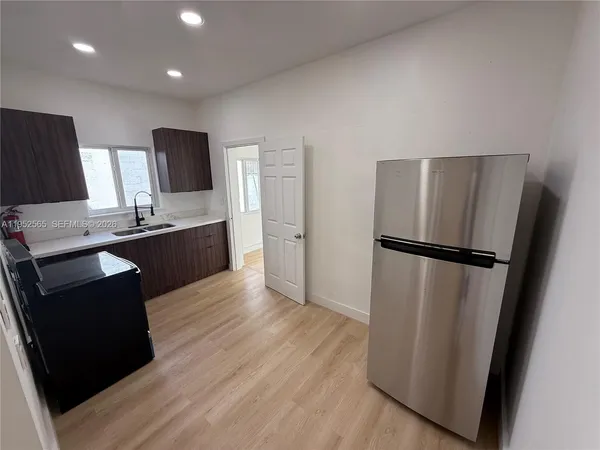 a kitchen with stainless steel appliances a refrigerator stove and microwave