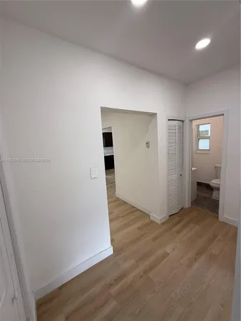 an empty room with wooden floor and closet