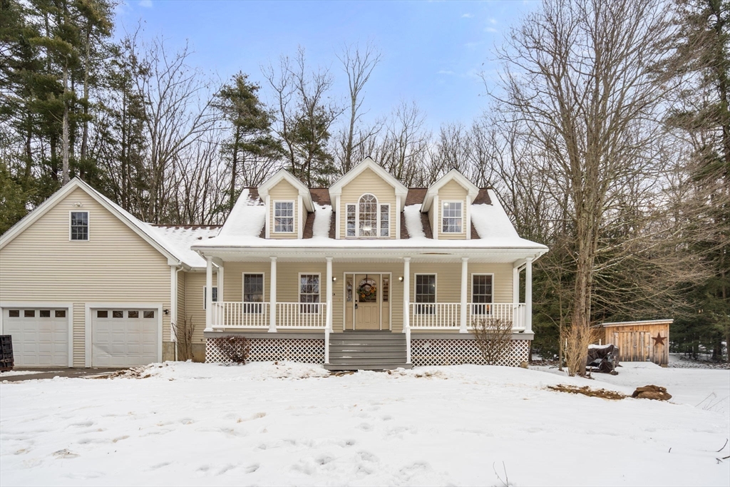 66 A New Boston Road Sturbridge, MA 01566 - Photo 1 of 29 a front view of a house with a yard covered in snow