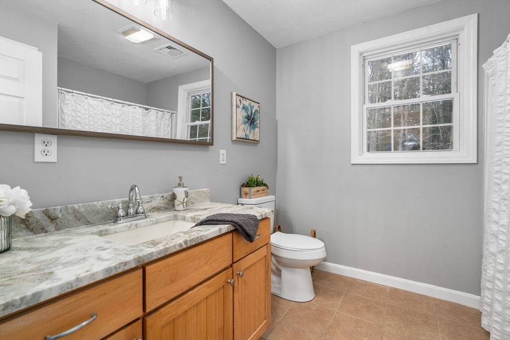 66 A New Boston Road Sturbridge, MA 01566 - Photo 17 of 29 a bathroom with a granite countertop toilet sink and mirror