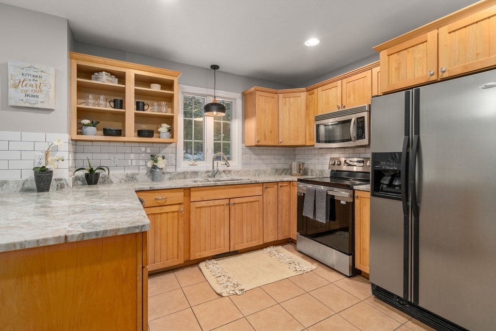 66 A New Boston Road Sturbridge, MA 01566 - Photo 7 of 29 a kitchen with stainless steel appliances granite countertop a refrigerator sink and cabinets