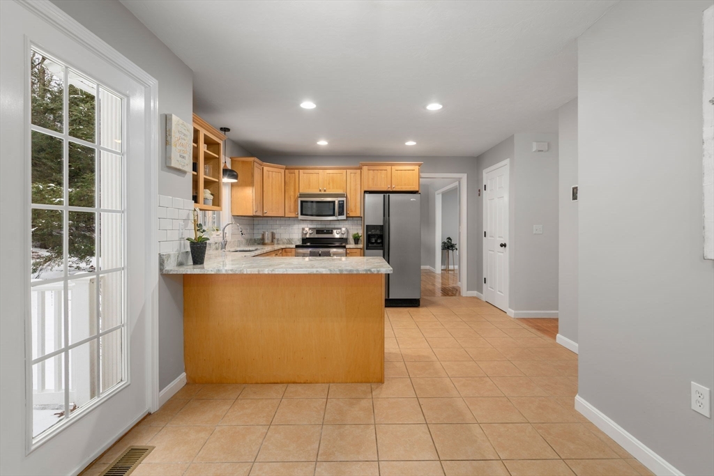 66 A New Boston Road Sturbridge, MA 01566 - Photo 9 of 29 a kitchen with stainless steel appliances a refrigerator and a stove top oven