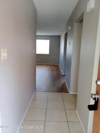 a view of a hallway to rooms