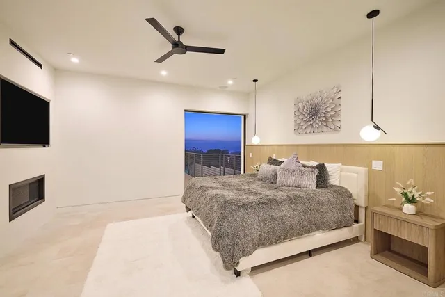 a bedroom with a bed a flat screen tv and dresser