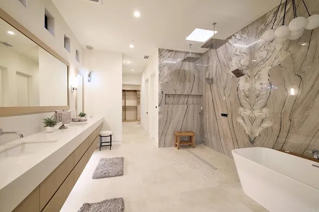 a bathroom with a double vanity sink toilet and shower