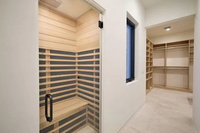 a view of empty room with wooden walls