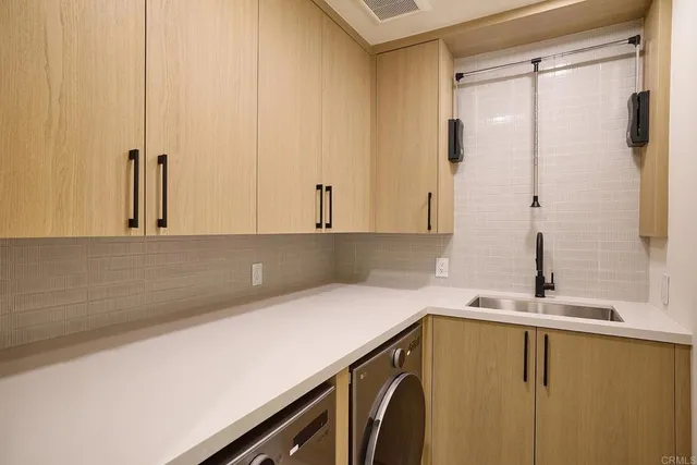 a close view of a sink a counter space and a stove in the kitchen