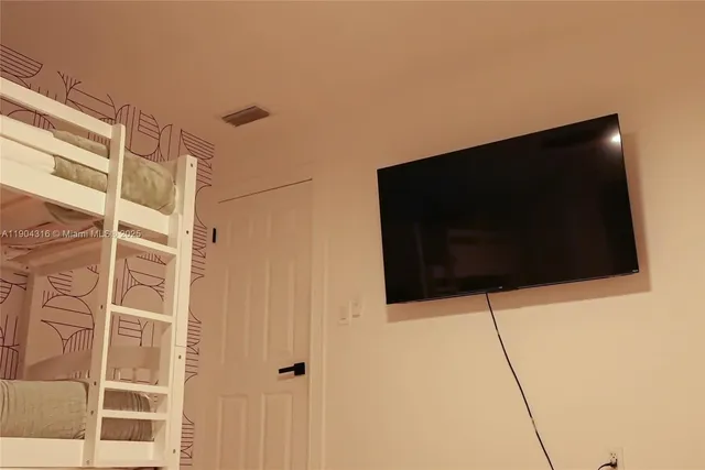 an aerial view of residential houses with outdoor space and street view