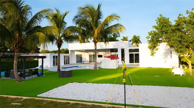 an aerial view of a house yard swimming pool and outdoor seating