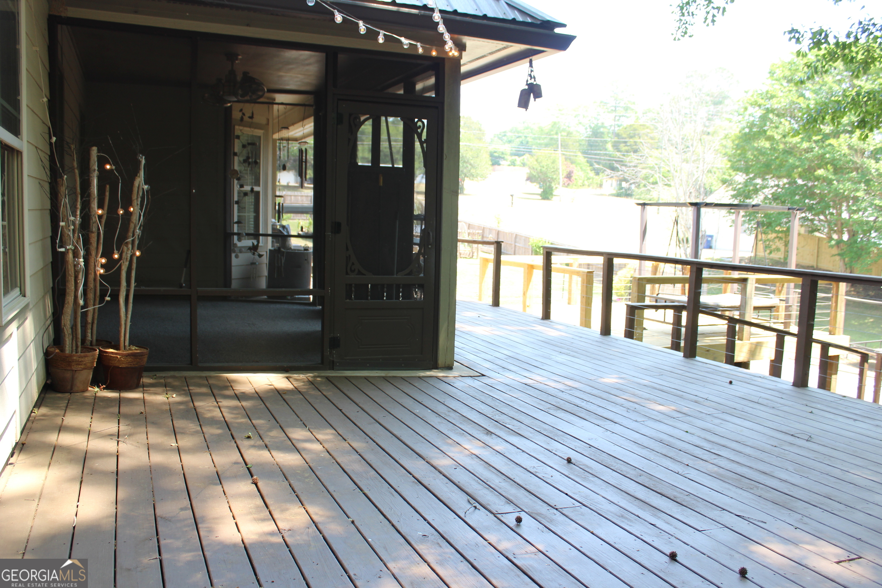 33 Lee Road Phenix City, AL 36870 - Photo 37 of 47 a view of porch with wooden floor and floor to ceiling window