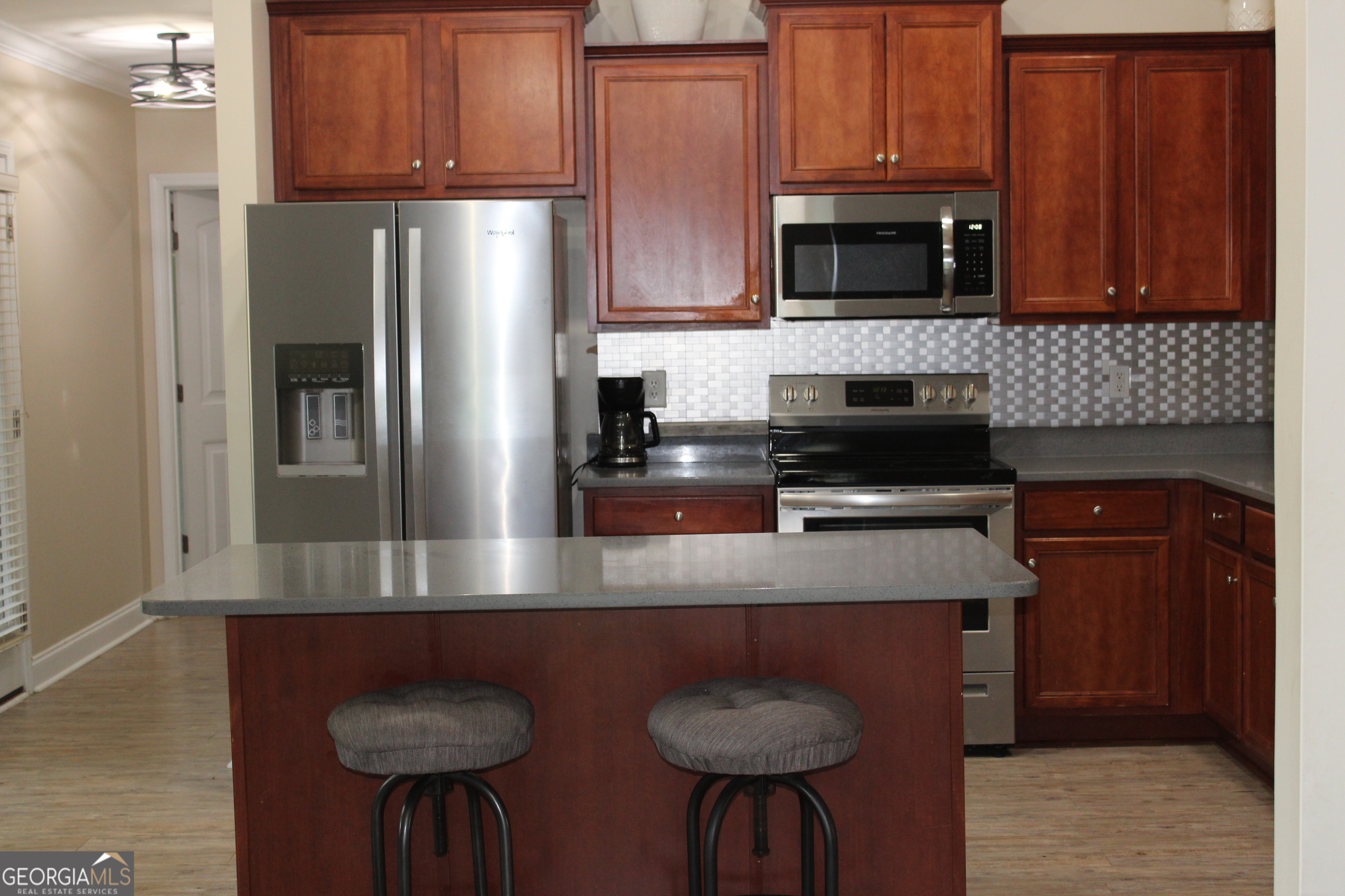 33 Lee Road Phenix City, AL 36870 - Photo 8 of 47 a kitchen with stainless steel appliances granite countertop a refrigerator stove top oven a sink and dishwasher