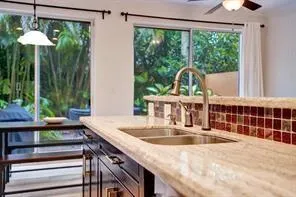 a kitchen with a sink and a large window
