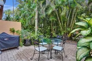 a view of a chairs and table in the backyard