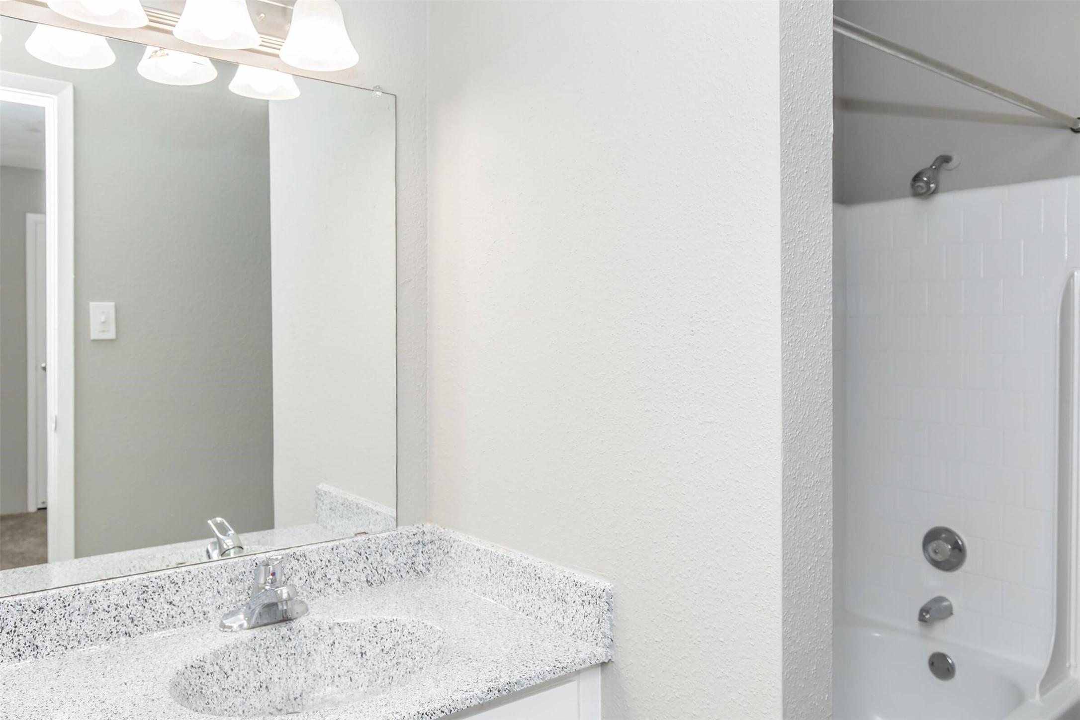 18001 Cypress Trace Road, Unit 506 Houston, TX 77090 - Photo 16 of 32 a bathroom with a granite countertop sink and a mirror