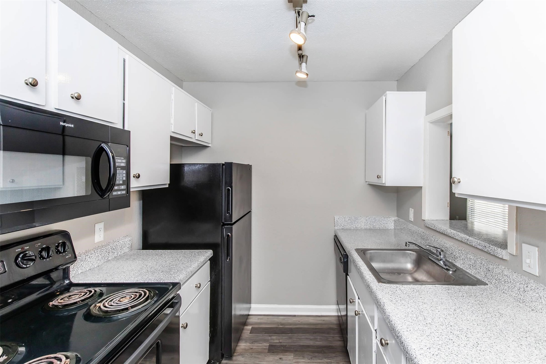 18001 Cypress Trace Road, Unit 506 Houston, TX 77090 - Photo 6 of 32 a kitchen with stainless steel appliances granite countertop a sink stove and refrigerator