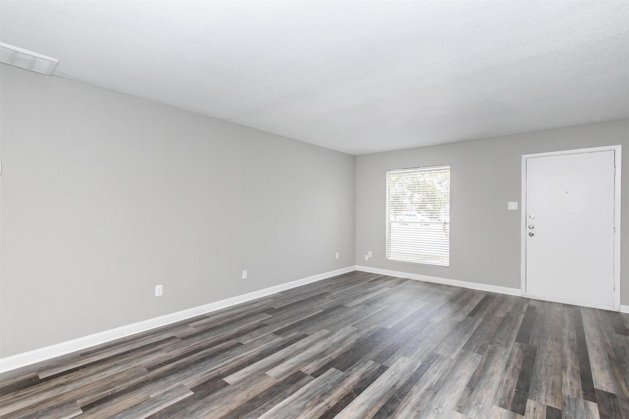 18001 Cypress Trace Road, Unit 506 Houston, TX 77090 - Photo 7 of 32 a view of an empty room with wooden floor and a window