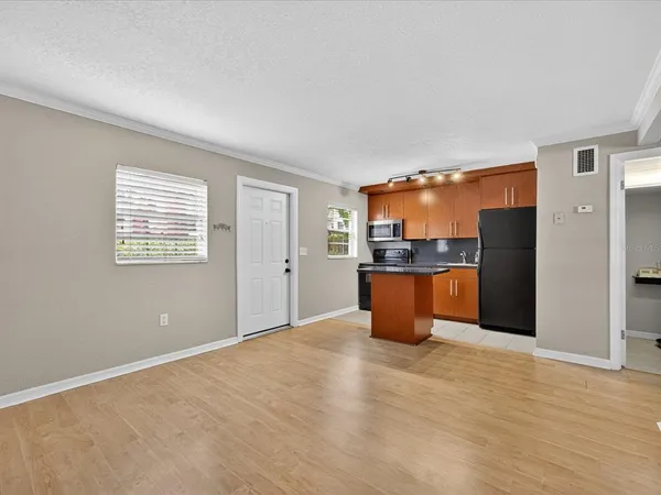 a view of kitchen with stainless steel appliances a refrigerator and a stove