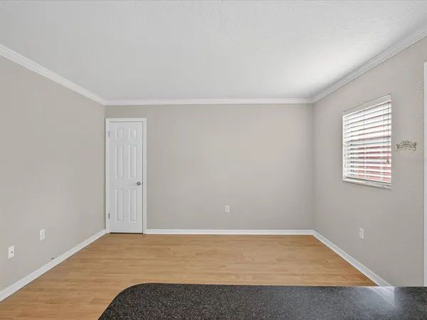 a view of a workspace with furniture and window