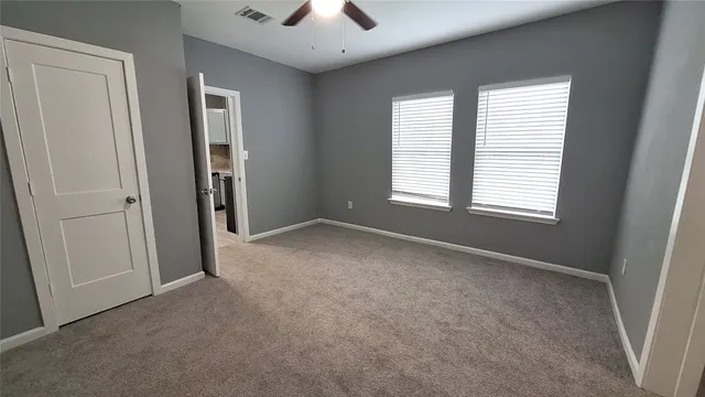 an empty room with windows and closet