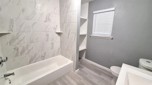 a bathroom with a bathtub and window