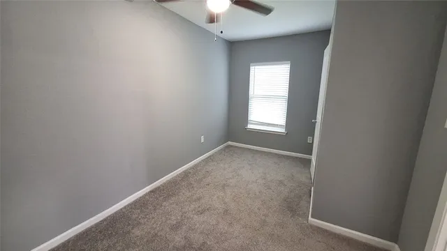 an empty room that has a window in it