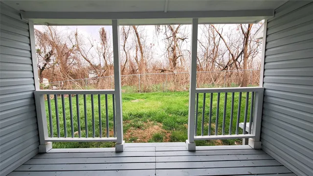 a view of a glass door with a trees in a yard