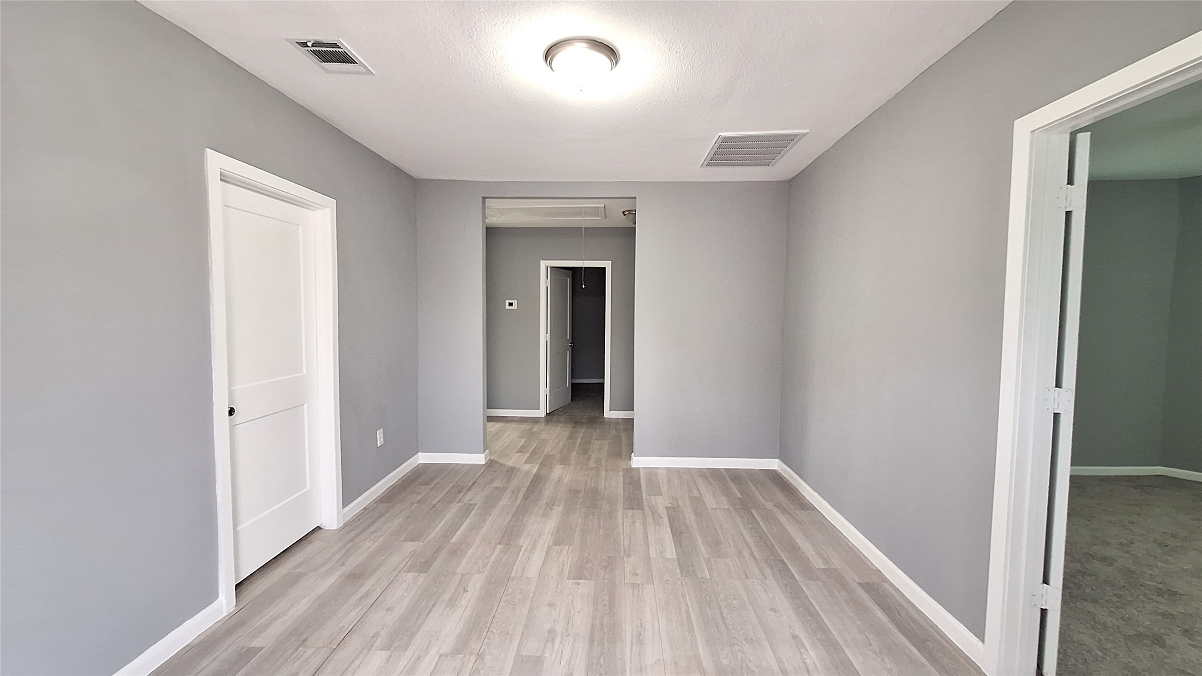 601 Armstrong Somerville, TX 77879 - Photo 4 of 28 a view of a room with wooden floor and a hallway
