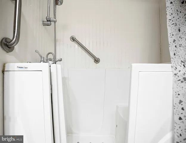 a bathroom with a shower and a sink