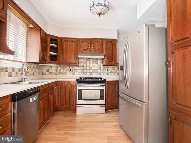 a kitchen with a refrigerator sink and stove