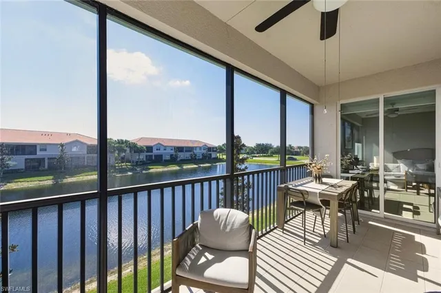 a view of a balcony with furniture and a floor to ceiling window