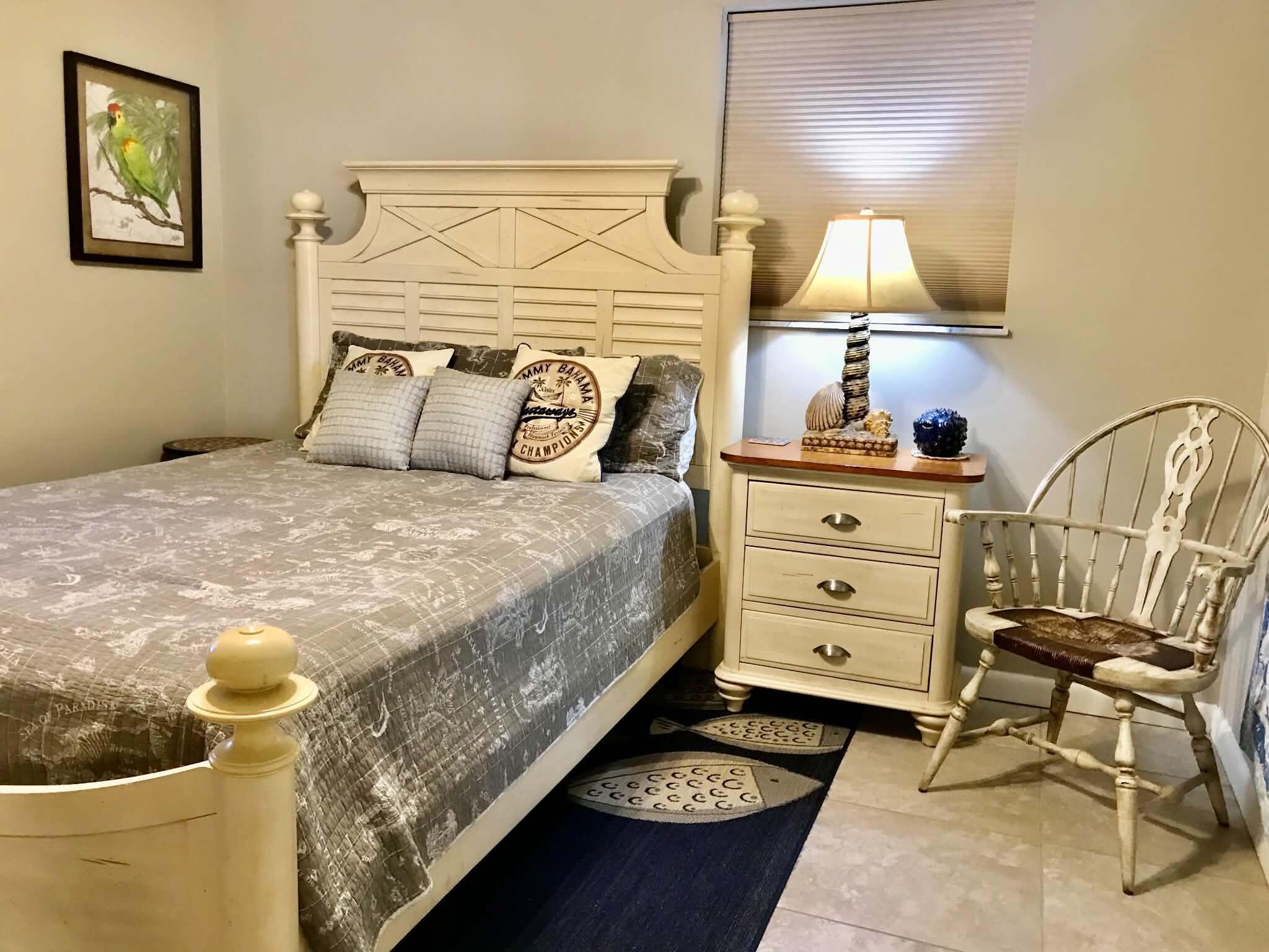 1115 Elm Street Okeechobee, FL 34974 - Photo 21 of 37 a bedroom with a bed and lamp on the dresser
