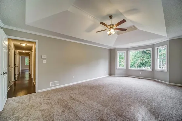 a view of a livingroom with a ceiling fan and window