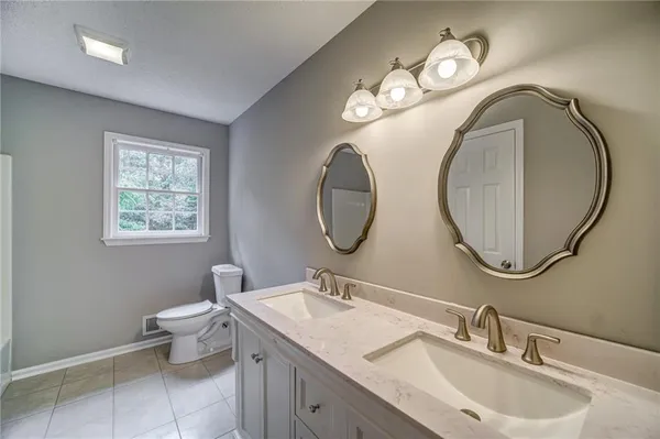 a bathroom with 2 sink and a mirror