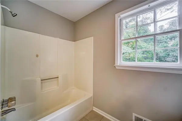 a bathroom with a bathtub and window
