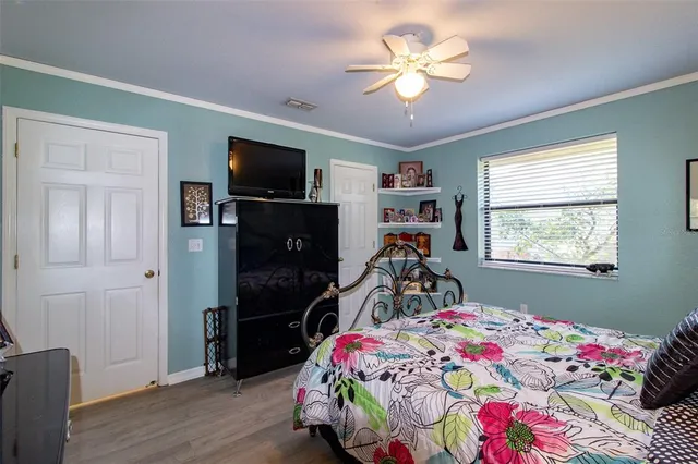 a bedroom with a bed and a flat screen tv
