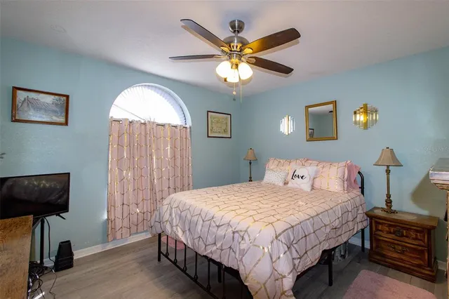 a bedroom with a bed and a chandelier