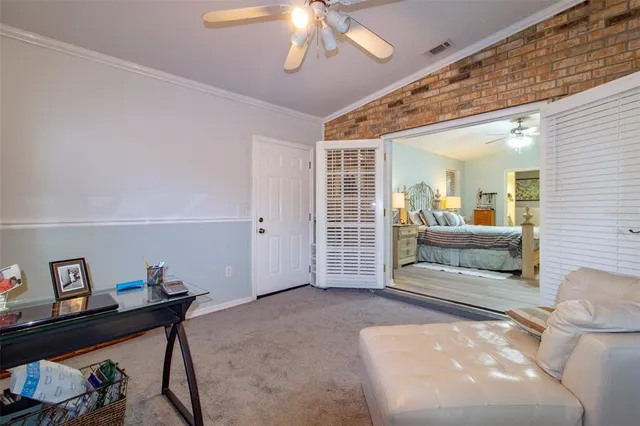 a spacious bedroom with a bed and a chandelier