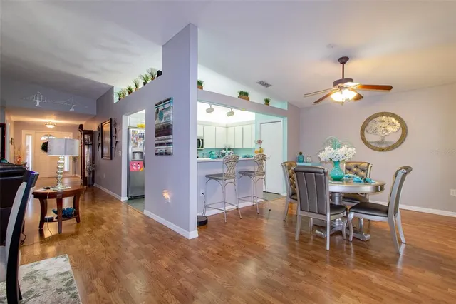 a view of a dining room with furniture and wooden floor