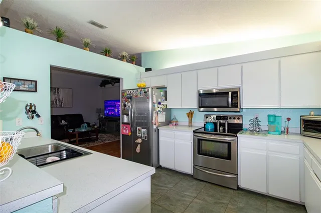 a kitchen with a sink a stove and refrigerator