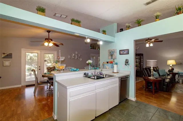 a kitchen with a sink stove and view living room