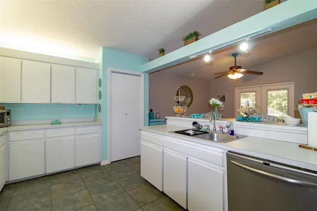 a kitchen with a sink and cabinets