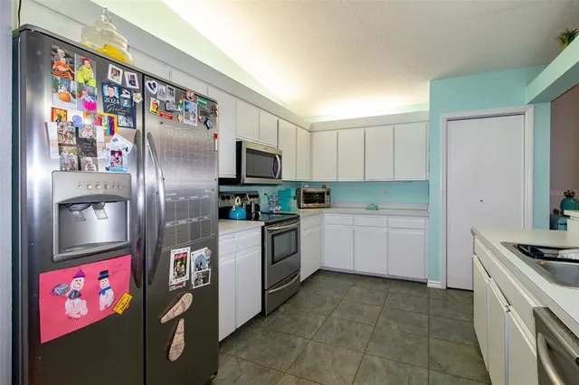 a kitchen with stainless steel appliances and cabinets