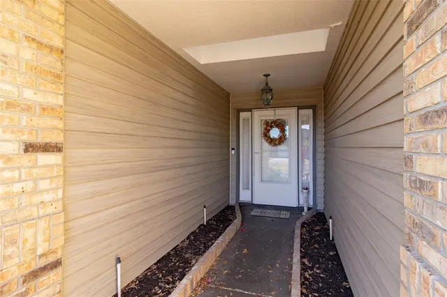 a hallway with wooden floor and a rug