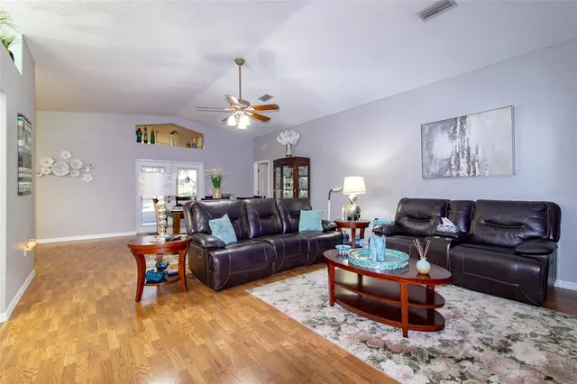 a living room with furniture and a chandelier